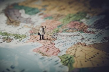 Miniature businessman on map of Europe Miniature businessman on map of Europe. Color tone tuned